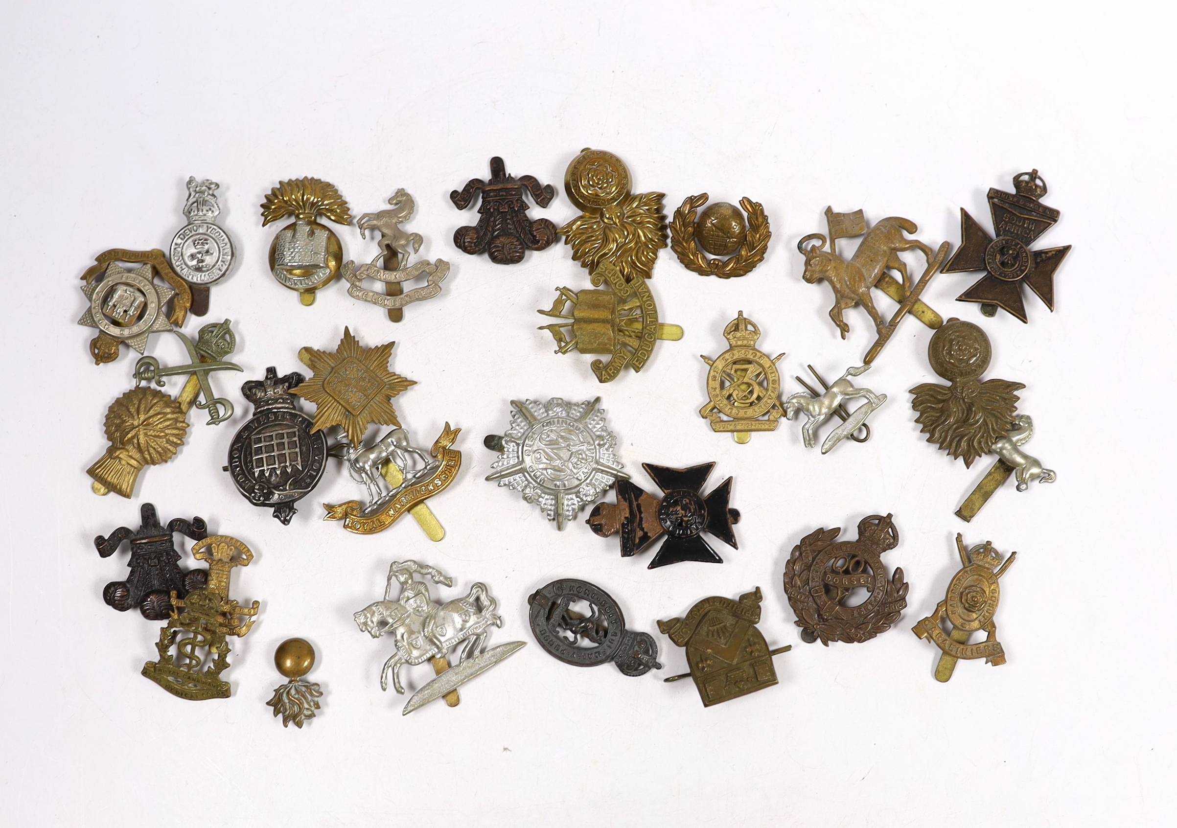 Thirty military cap badges including Royal Warwickshire, Hampshire Yeomanry Carabiniers, Inniskillin, Royal Canadian, AMC, Dorset, Army Educational Corps, London and West Rifle Volunteers, etc.